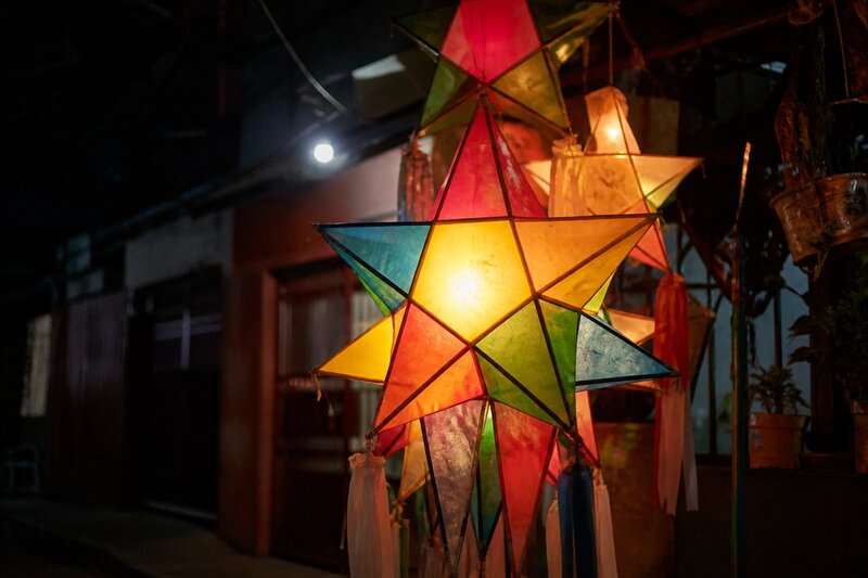 Colorful star-shaped Filipino parol lanterns glowing against the night