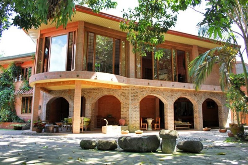 Serene grounds of Ugu Bigyan's pottery garden with handcrafted pieces and lush landscaping